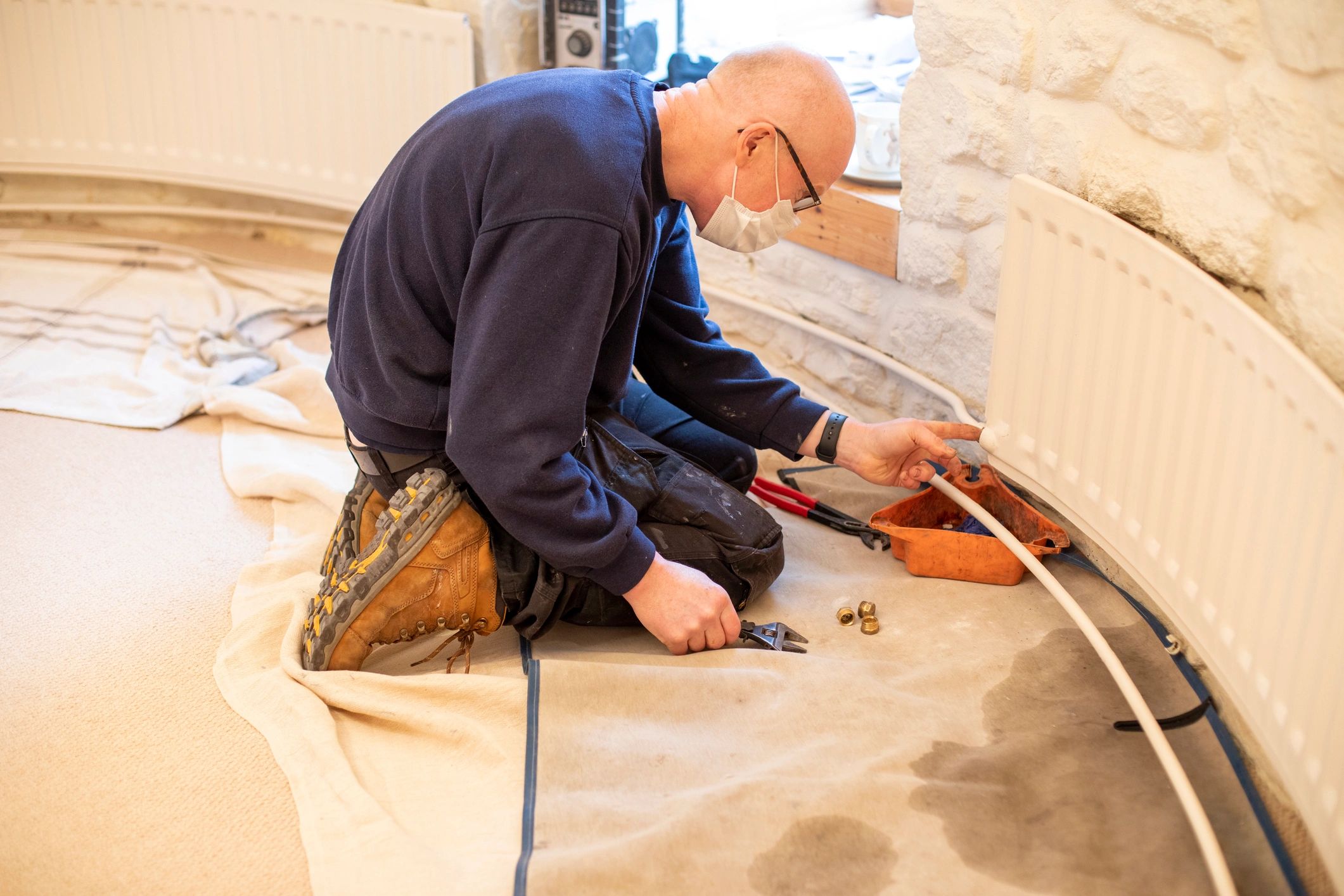 Tradesperson carrying out maintenance repair work indoors